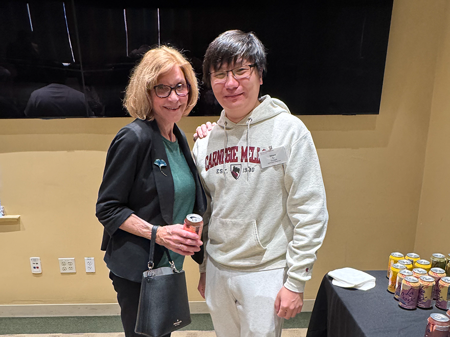 alum and professor pose for photo