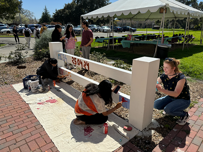 Student paint fence on campus